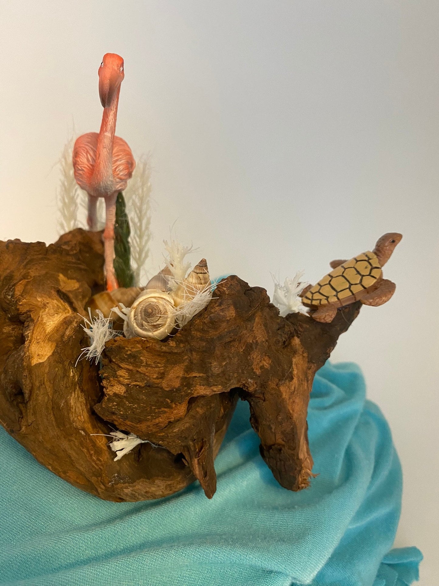 Driftwood coastal scene with flamingo and turtles