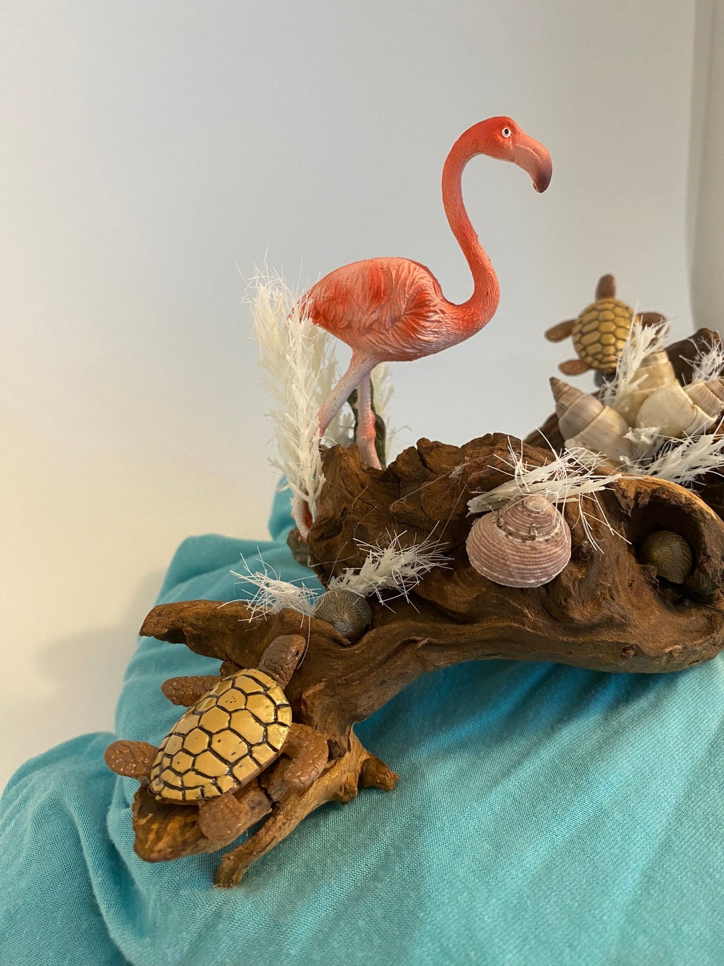 Driftwood coastal scene with flamingo and turtles