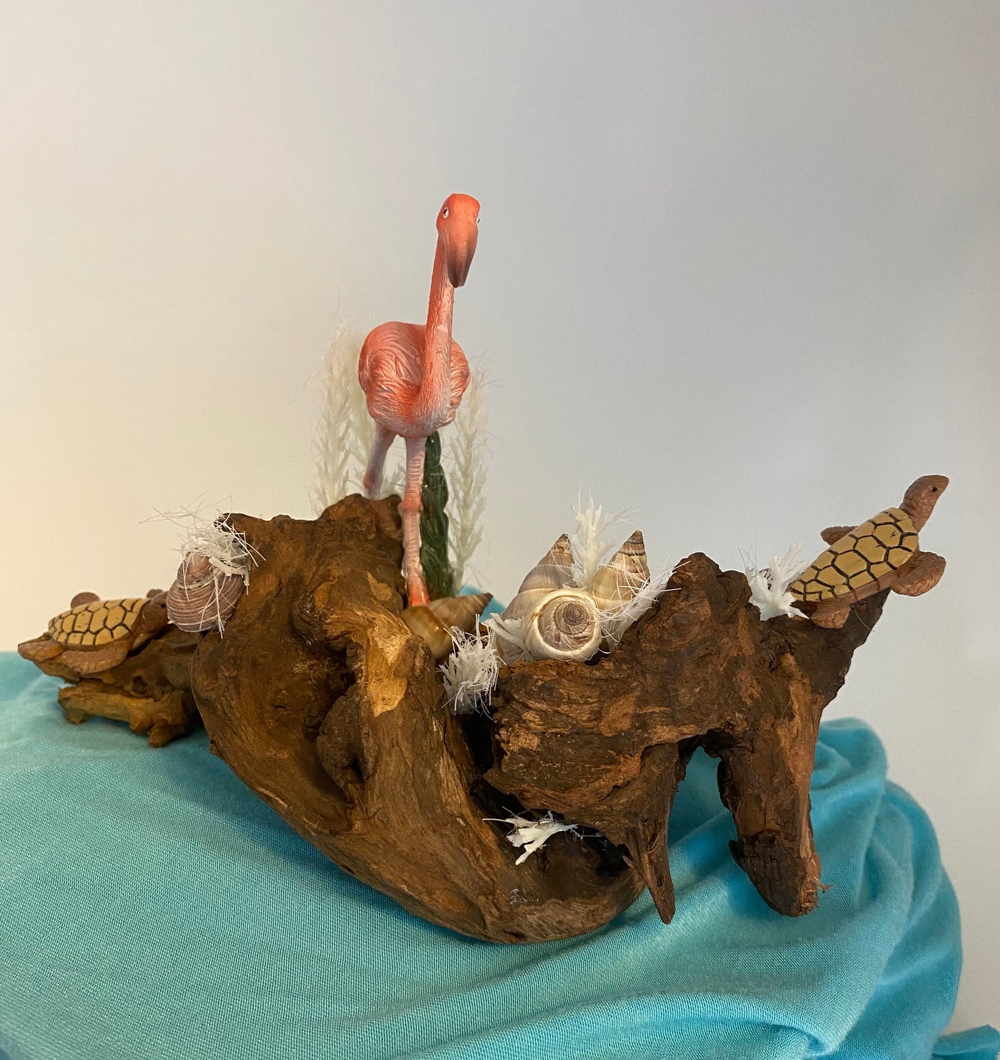 Driftwood coastal scene with flamingo and turtles