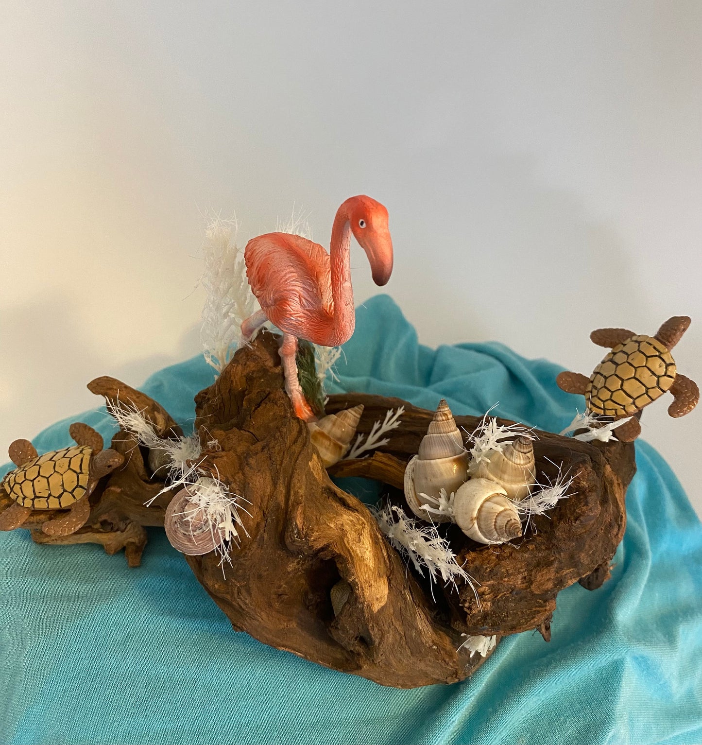 Driftwood coastal scene with flamingo and turtles