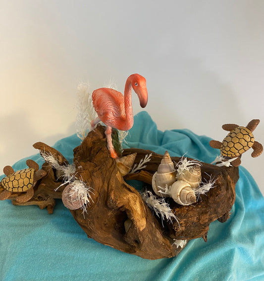 Driftwood coastal scene with flamingo and turtles